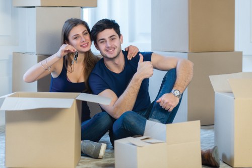 Professional movers packing items for storage in London