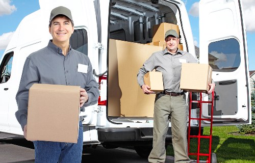 Professional removalists loading furniture into a truck